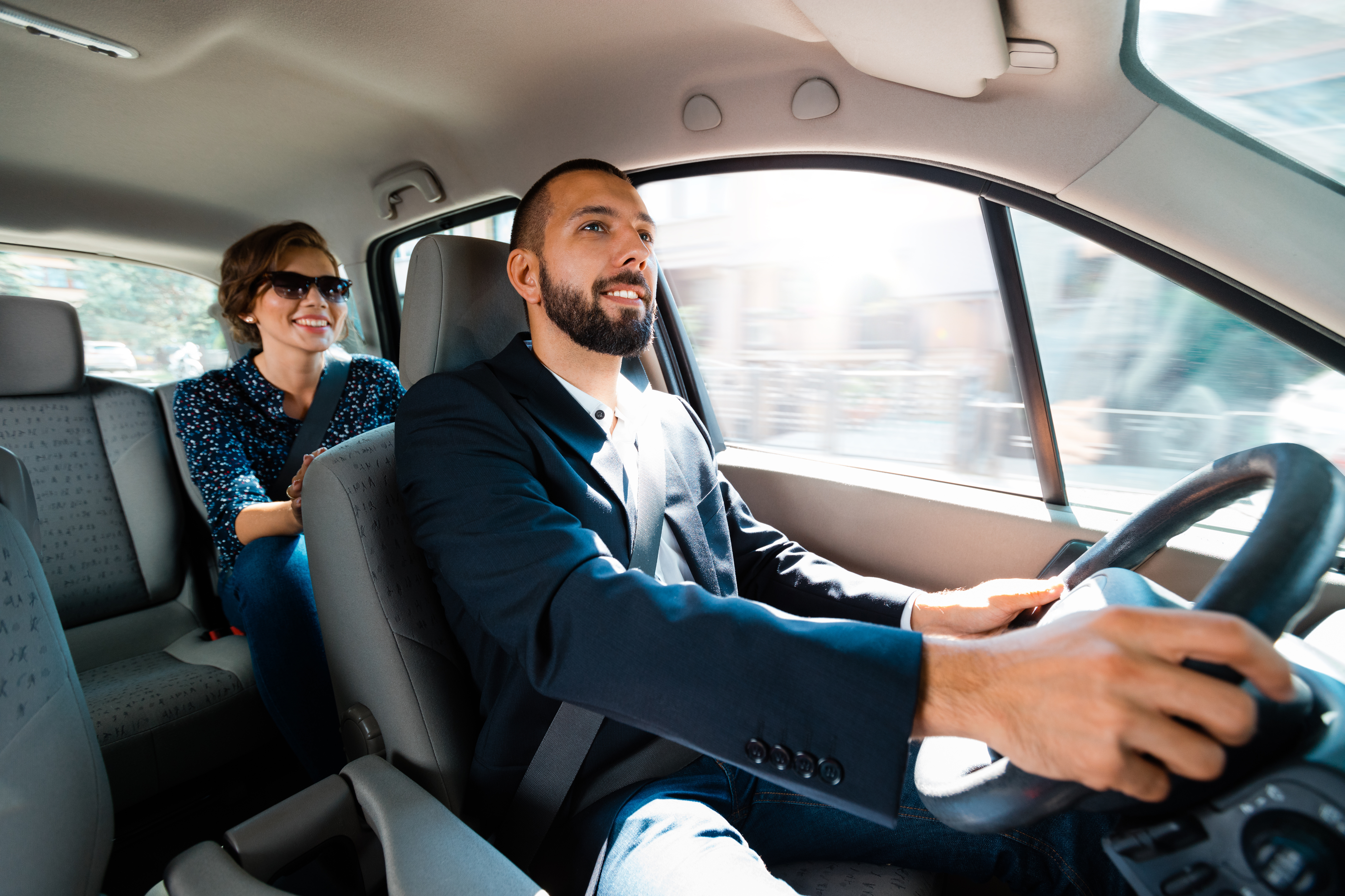 Uber driver and passenger representing asset insurance needs for ride-hailing side hustles in South Africa