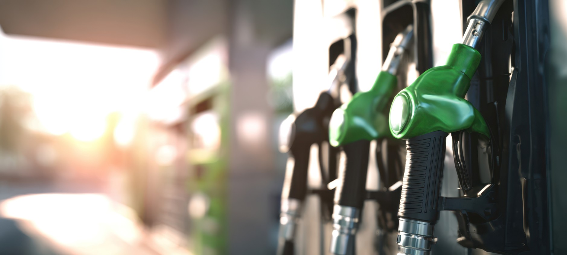 Green fuel pump nozzles at a petrol station representing the 2026 fuel price increase in South Africa