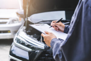 man checking his car maintenance checklist for better performance