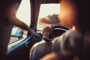 a person driving on a South African road, symbolizing the need for car insurance.