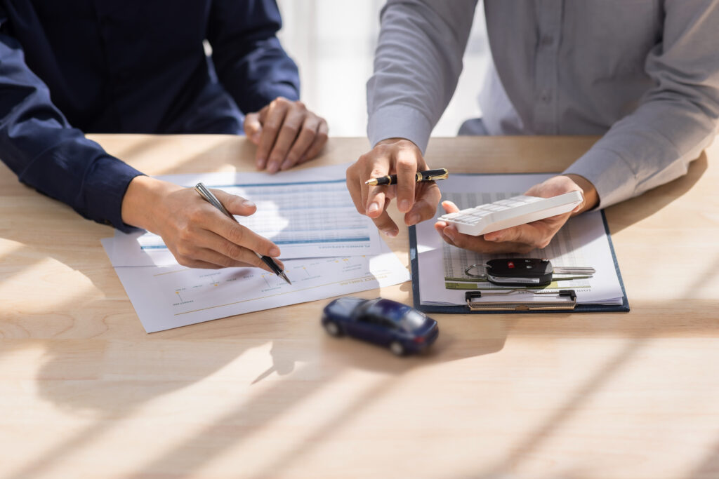 Two people reviewing liability insurance documents at a desk